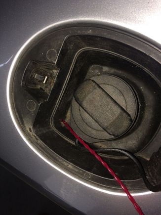 The worlds smallest fuel drain hole , right in the bottom corner .Use the cord or compressed air to clear .