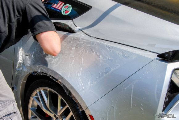 Jon is installing XPEL ULTIMATE on the rear quarter on this Corvette