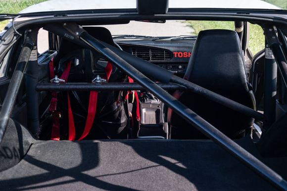 Photo with rear hatch open showing Matter cage, new(er) Schroth harnesses to compliment street seat belts. Notice Matter decals intact throughout the car.