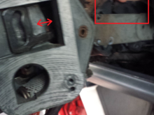 There's this slot in a pivoting mechanism that that actuator arm has to slide into that's right under where my finger is. You can see here it's stuck and won't let the actuator arm go in.