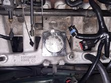 You can see the fitting installed right next to the TB hole.