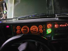 I fit two in the blank panel. Had to make a smoked cover for them since the gauges dont dim. 
