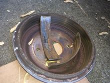 Ruined Brake Shoes. Whatever the hell they use as adhesive wore out, allowing the brake shoes (pictured here, inside the drum) to come apart from their mount and get jammed inside the drum, locking my rear tire.