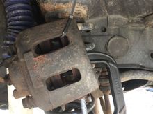 Hang the caliper with wire or a zip tie.
