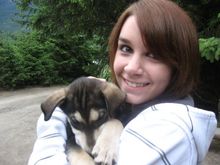 me holding a husky puppy in alaska.