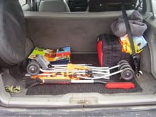 This is my setup in my trunk. As you can see, I have a stroller, snow brush, reusable grocery bags, a cover, towels, tow strap, rope, a bottle of oil and an emergency kit. The kit has the following in it: first aid kit, shovel, poncho, cover, air compressor, tow strap (another one), multi purpose tool, gloves, flashlight and those red triangles. Might forgot something, but anyways :P