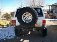 TIRE CARRIER W/35X12.50 ON 15X10 RIMS