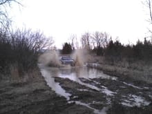 friends bone stock grand with bald tires going through 3 ft of mud and water