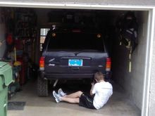My buddy jeremy tapping out the last rusted weld nut so we can install the hitch