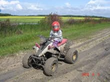 normally a dry dirt farm road, but it's been like this all spring and summer. no, our daughter does not drive this quad. check the water in the fields in the back ground, that's from days and days of rain, farmers cannot get onto the fields.