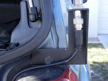 Installed on a 97+ Jeep Cherokee XJ, finished with black rustoleum. A slight bend applied to the top-left of the mount to fit around the lip below the back hatch gasket. 