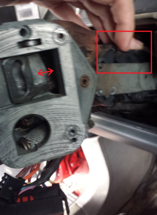 There's this slot in a pivoting mechanism that that actuator arm has to slide into that's right under where my finger is. You can see here it's stuck and won't let the actuator arm go in.