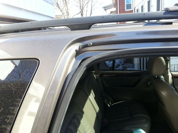Exterior view of short or shrunken door gasket, upper-left corner of right rear passenger door frame