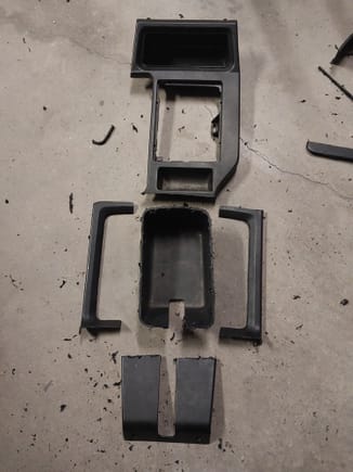 I cut up another center console inlay and sectioned it out. You can see here I separated the surrounding bezel that used to be the top of the bucket for the emergency brake.