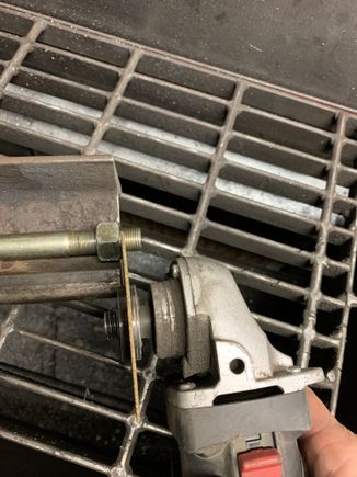 Use the nut as a guide to cut the bolt square.