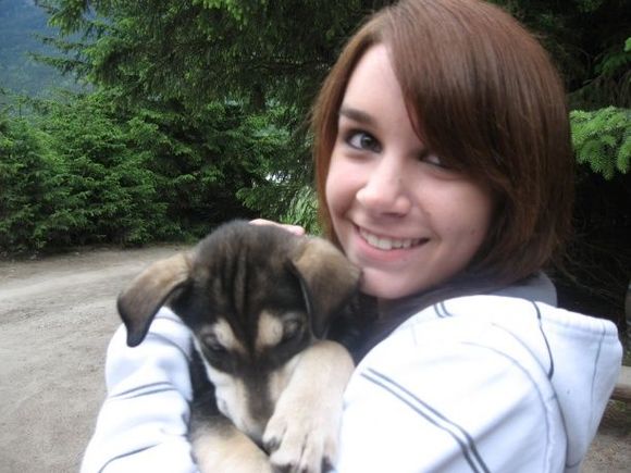 me holding a husky puppy in alaska.