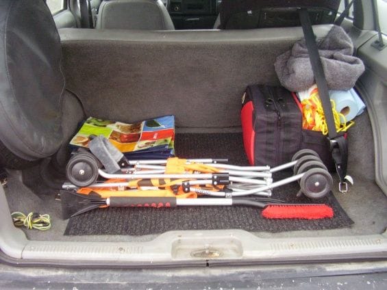 This is my setup in my trunk. As you can see, I have a stroller, snow brush, reusable grocery bags, a cover, towels, tow strap, rope, a bottle of oil and an emergency kit. The kit has the following in it: first aid kit, shovel, poncho, cover, air compressor, tow strap (another one), multi purpose tool, gloves, flashlight and those red triangles. Might forgot something, but anyways :P
