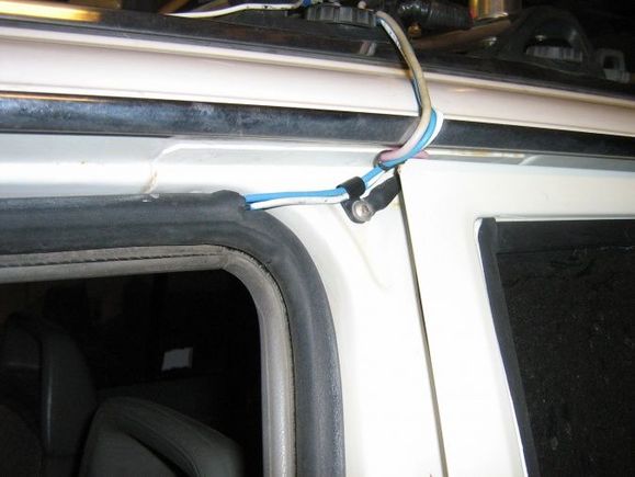 I sneak my dual 12ga feed wires thru the door weatherstrip and ground heavy 10ga (both sides) to the B pillar.IMG 2473
