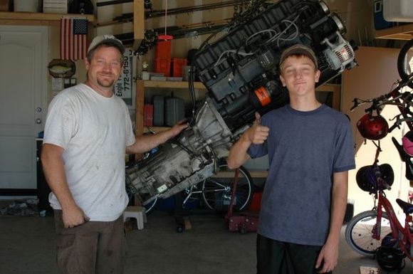 me and my dad infront of my newly rebuild engine and tranny!