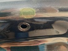 Passenger side above the fastener hole