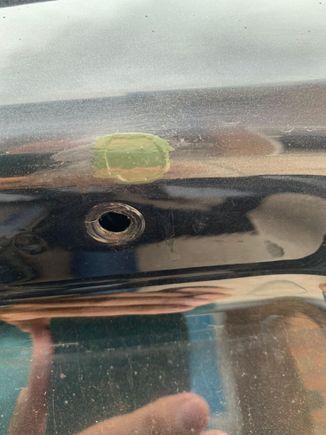 Passenger side above the fastener hole