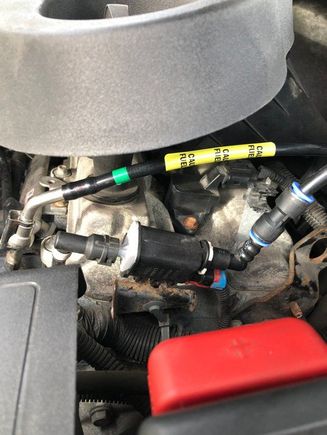 The line with the yellow label is the pressurized fuel line going to the injector log, the other line is the vapour line connecting to the Evap purge valve then to the intake manifold, no connection to the fuel of any kind. 