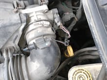 Can you tell me what this is and if it goes in that hole next to it. I bought this car from a car dealership a few months ago I don't drive it all that much. I was looking under the hood and noticed it. Thanks for all help 
