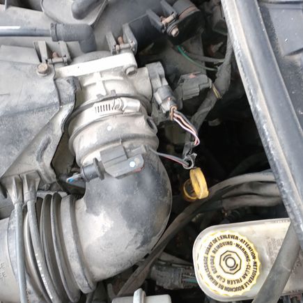Can you tell me what this is and if it goes in that hole next to it. I bought this car from a car dealership a few months ago I don't drive it all that much. I was looking under the hood and noticed it. Thanks for all help 