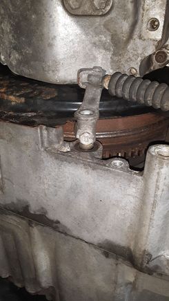 Gear selector cable holding nut - 10mm.  Move locking tab away from nut with small screwdriver.