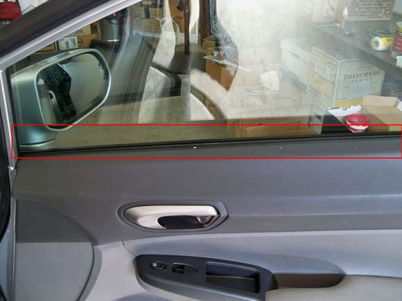 Front Passenger Door. Red rectangel around rubber against window.