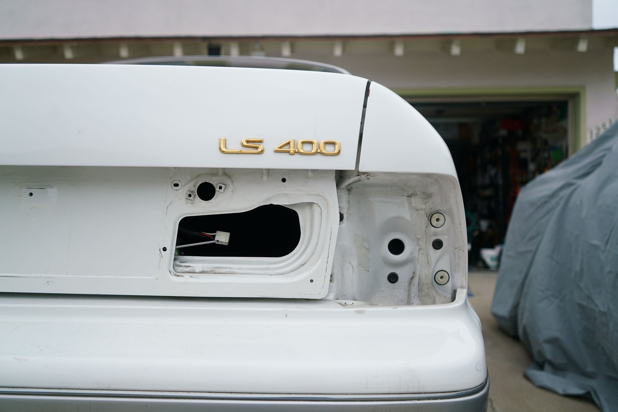 Pulled the rear tails to buff the trunk panels and clean behind the tails.
