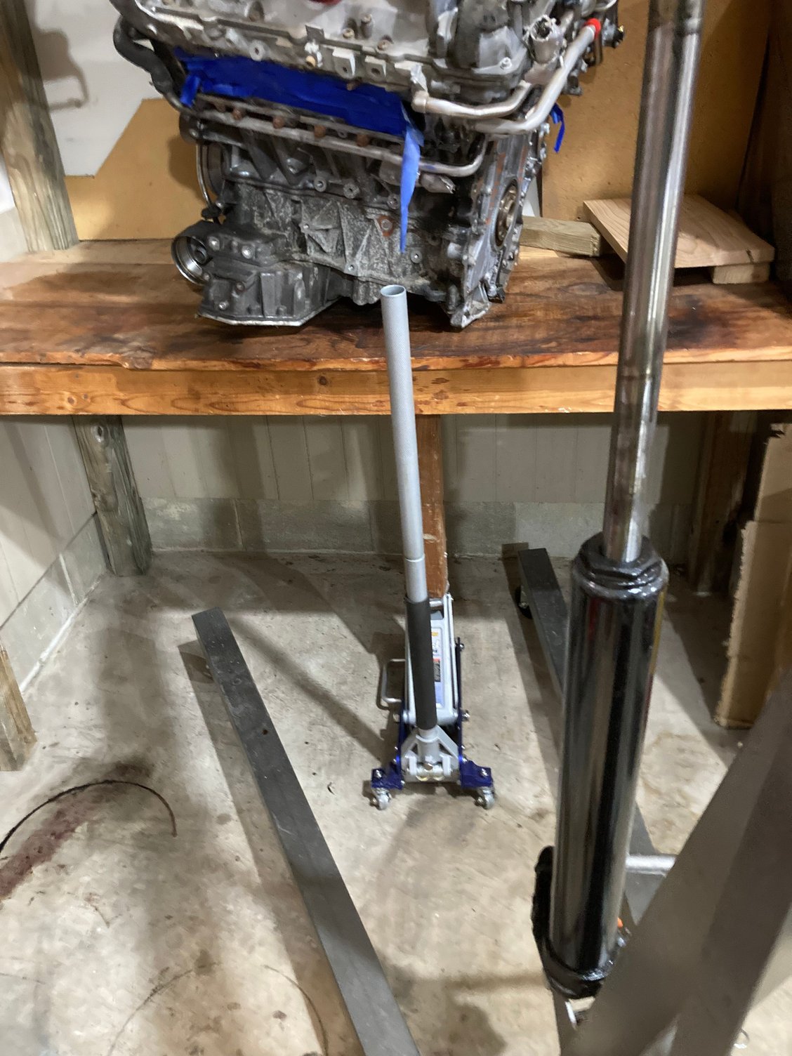 I underestimated the weight.....had to reinforce the bench. I have this shelf setup to allow me to move the engine around/rotate it as needed. Spare small parts I'm keeping on the 