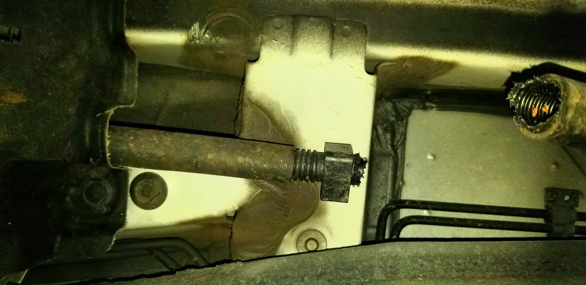 Broken hose under driver's side mid-way between front door and rear door.