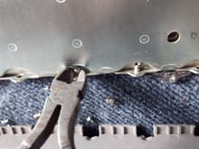 Grabbing the shank with pliers and pulling / twisting is the easiest way to remove them.  You'll notice due to the shape of the metal bracket you cannot simply punch the shank out of the hole it has nowhere to go (when the pack is assembled).