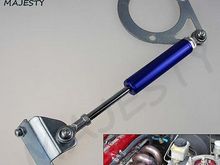 Found this image online.....The strut mount bracket is a possibilty but the solid heim joints on thr damper are not the best solution for  improving engine damping  while maintaining  engine - body isolation. Moreover, this  unit is apparently mounted wirhout a counterpart  which excludes it in my mind. Also, would prefer a configuration that maintains engine top cover..