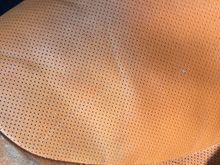 This is my driver seat. You can see I used some of the crack filler. On the perforated panel, I tested the leather dye. You can see the dye is on the left portion and the right is not dyed.