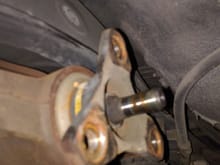After removing the exhaust, and exhaust heat-shield, remove the driveshaft. This is three bolts on the Rear Diff end, and three bolts on the transmission end. Then two bolts at the center yolk.