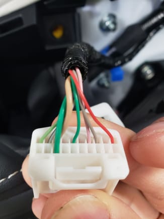 This is the same connector except turn so that you can see the other side.  Here you will see the thicker green wire notice it's the only wire on this side.  This is the 12-volt wire that will become live when you have your headlights on.