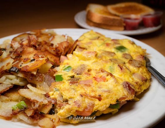 Hobo omelette: bacon sausage, ham, bell peppers, onions, mushrooms and country potatoes.