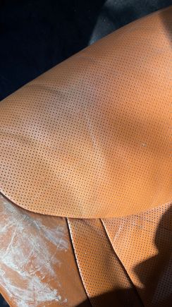 This is my driver seat. You can see I used some of the crack filler. On the perforated panel, I tested the leather dye. You can see the dye is on the left portion and the right is not dyed.