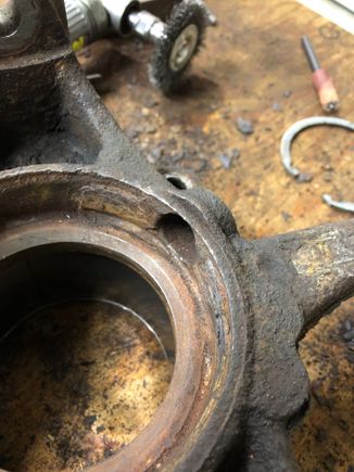 Rust buildup inside the knuckle. This causes the dust shield around the axle to warp and it crimps around the ABS tone ring. This is what's causing the wear on the tone ring