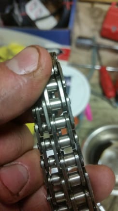 Old timing chain I had lying around.  Looks like that chunk of metal is part of one of the rollers.
