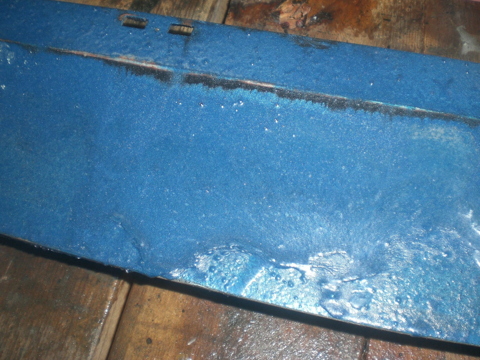 I first tried it out on the metal wiper door to see how it worked.  Here the softened paint is clearly visible.