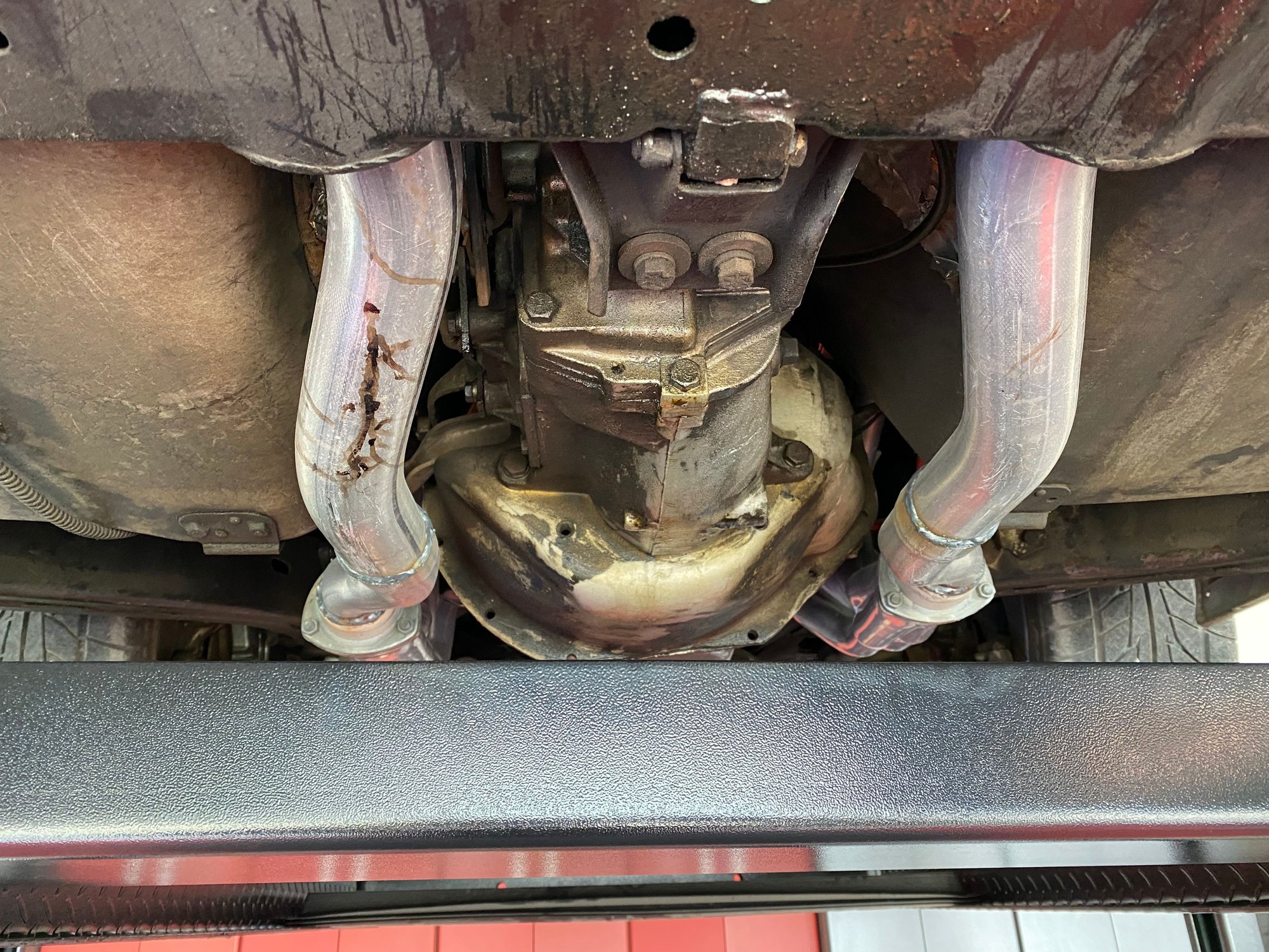 I don’t see any engine oil leaks, but the tranny is wet and has a drop hanging from the mount