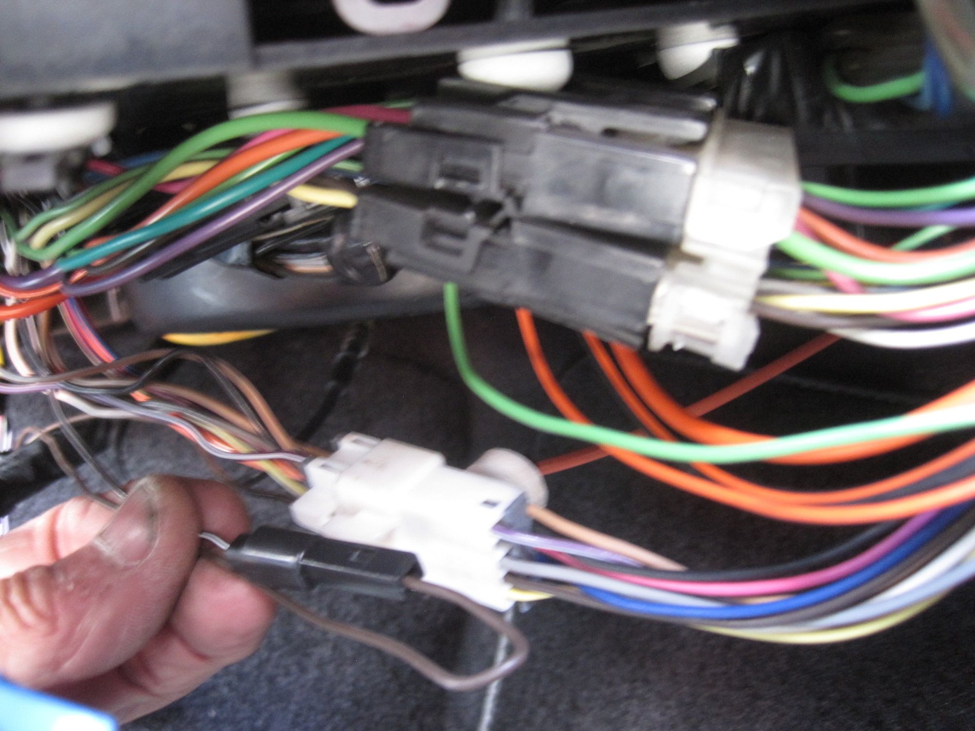 The brown wire in the 1-cavity connector in the foreground was removed from the 10-cavity white connector behind it. This is the 
