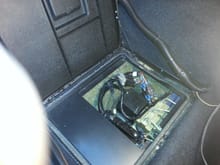 This is where the Electronic Brake Traction Control Module lives. a trap door directly behind the drivers seat. It does not lift easily, and when you do it has a black insulation mat that hides all this, you have to lift out the mat to see this.