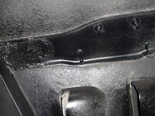 Two holes filled under cross flag Fender emblems.