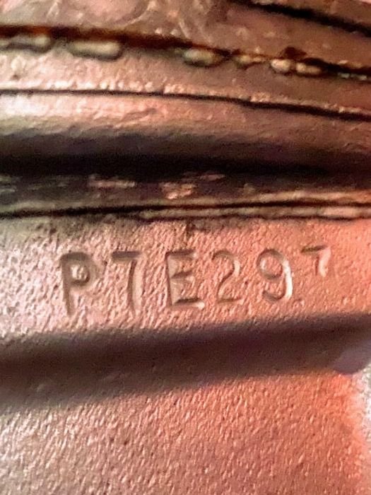 Smaller "7" or possibly "v" after the dates on transmission stamp