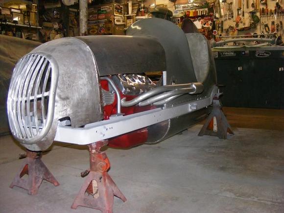 side shot of a midget race car with a v8-60 engine