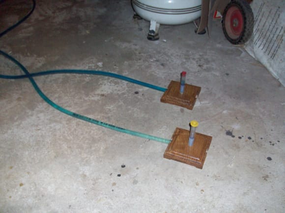 Water level made from 10 feet of 3/8" vinyl tubing, 2ea 90 deg elbows, and scrap wood routed for tubing. Water is dyed blue. I also use it to level my pool table.